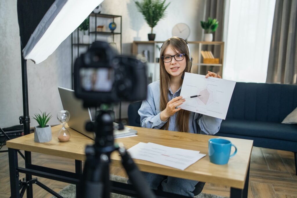 Business woman recording masterclass on video camera