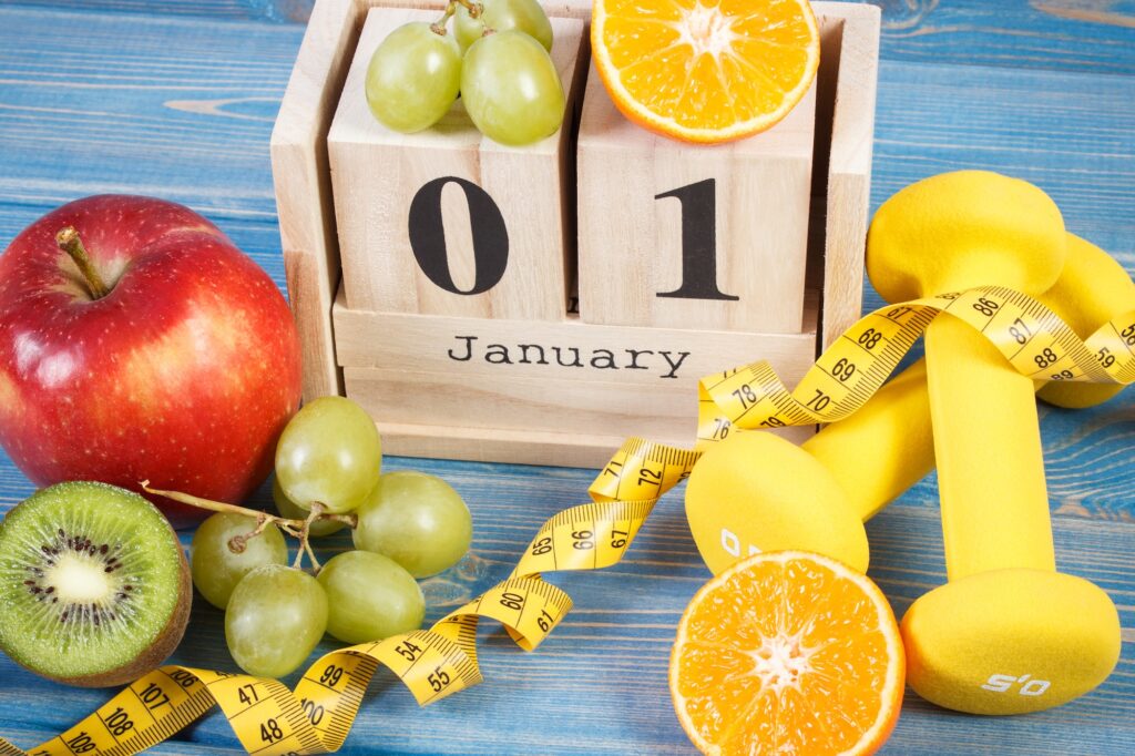 Cube calendar, fruits, dumbbells and tape measure, new years resolutions