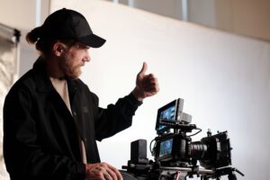 Director of production studio or crew showing thumb up gesture to his team