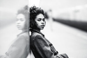 Greyscale portrait of black girl at the metro station