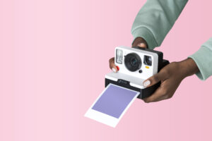 Hands holding an instant camera photo