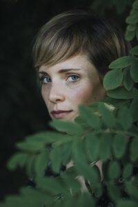 Portrait of a woman behind leaves